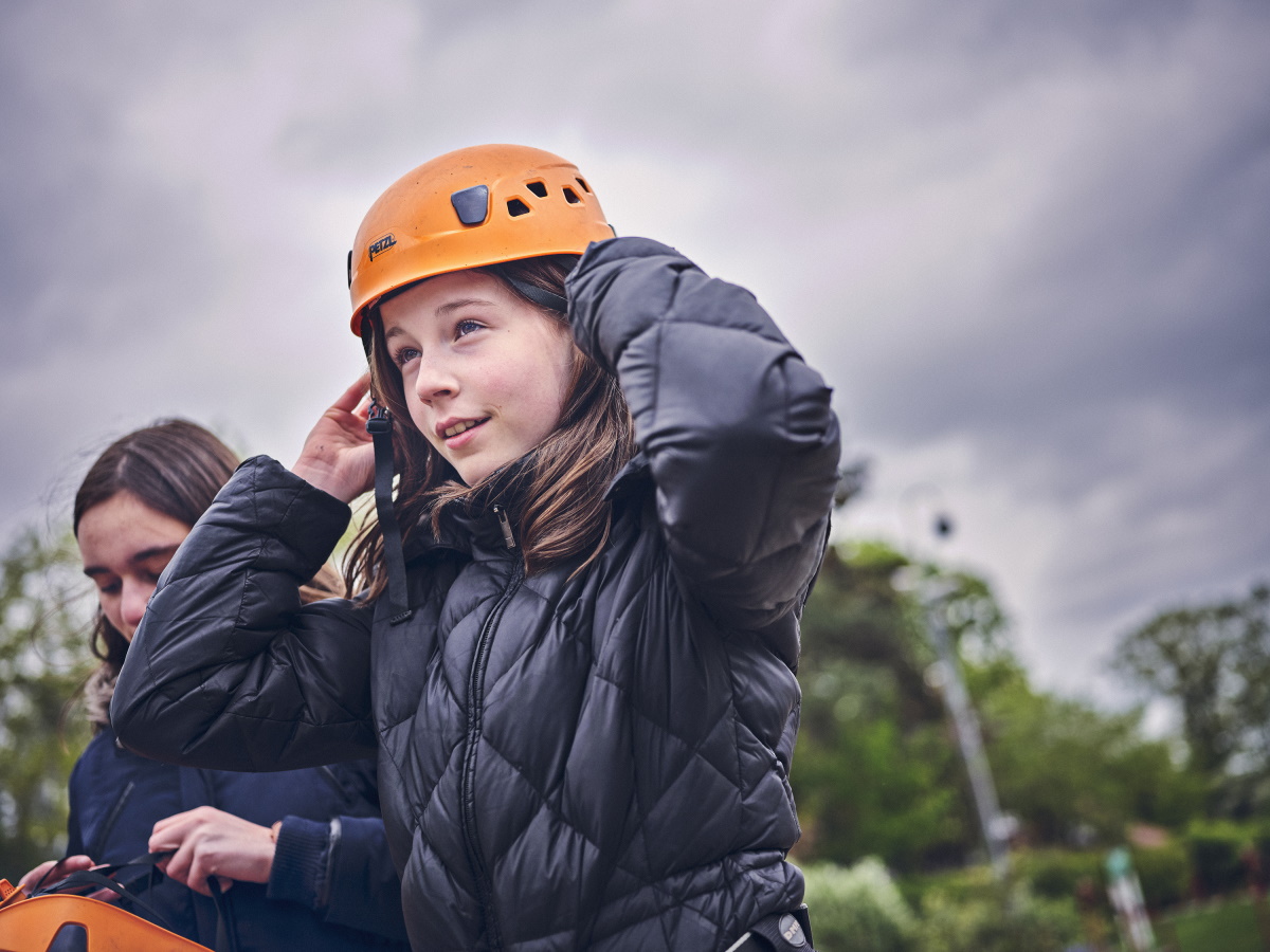 Image of a Scout putting on a safety helmet
