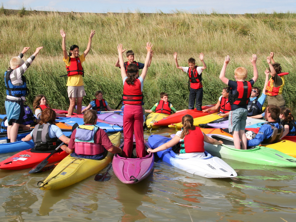 Image of a group of Scouts stood on top of kayaks